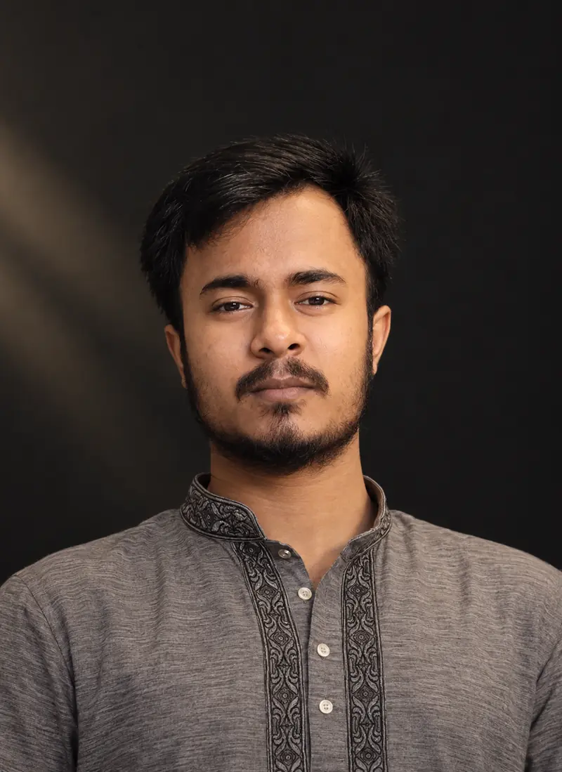 Portrait photo of Humayon Kabir, a UX designer, wearing a grey embroidered kurta